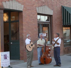 Folk Trio in front of Harrington Opera House