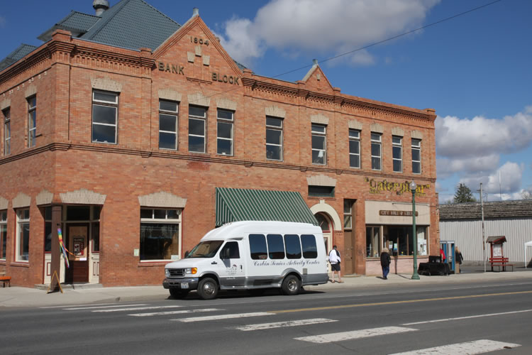 Corbin Senior Activities bus in front of Harrington Opera House