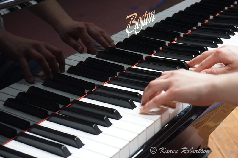 childs fingers on piano keyboard