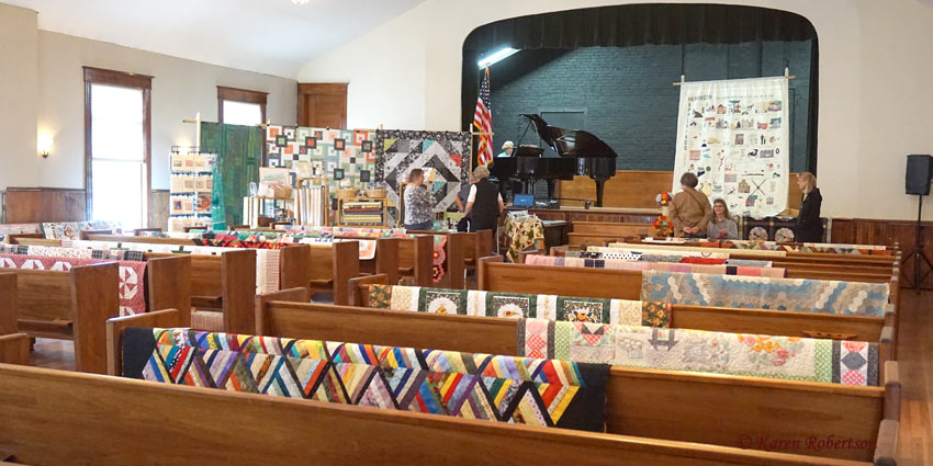 Quilts displayed in Harrington Opera House auditorium